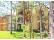 Exterior of a three-story apartment building surrounded by lush landscaping and mature pine trees at 713 Crest Pines Dr # 227, Orlando, FL 32828