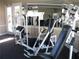 Community gym features modern weight training machines, carpeted floor and mirrored wall at 713 Crest Pines Dr # 227, Orlando, FL 32828