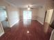 Spacious living room with wood floors, fan, and a sliding glass door providing natural light at 713 Crest Pines Dr # 227, Orlando, FL 32828