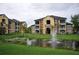 View of the pond with fountains and apartment buildings in the background at 713 Crest Pines Dr # 227, Orlando, FL 32828