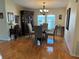 Elegant dining room with hardwood floors, chandelier and a large window for natural light at 723 Polo Park East Blvd, Davenport, FL 33897