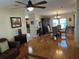 Open floor plan with hardwood floors, connecting living area, dining area and kitchen at 723 Polo Park East Blvd, Davenport, FL 33897