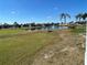 Picturesque pond view with a fountain, palm trees, and well-maintained green space in a serene community at 723 Polo Park East Blvd, Davenport, FL 33897