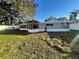 Spacious backyard featuring a screened-in porch and well-maintained lawn and white fence at 7331 Blue Jacket W Pl, Winter Park, FL 32792