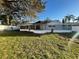 Spacious backyard featuring a screened-in porch and well-maintained lawn and white fence at 7331 Blue Jacket W Pl, Winter Park, FL 32792