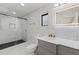 Contemporary bathroom features marble walls, an illuminated mirror, and glass enclosed shower at 7331 Blue Jacket W Pl, Winter Park, FL 32792