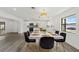 Bright dining room featuring modern chandelier and stylish black chairs, adjacent to the kitchen at 7331 Blue Jacket W Pl, Winter Park, FL 32792