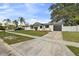 Charming single-story home featuring a well-maintained lawn, dark garage door, and welcoming curb appeal at 7331 Blue Jacket W Pl, Winter Park, FL 32792