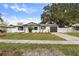 Charming single-story home featuring a well-maintained lawn, dark garage door, and welcoming curb appeal at 7331 Blue Jacket W Pl, Winter Park, FL 32792