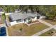 Charming home featuring white exterior, black trim, one car garage and a tidy front yard with garden at 7331 Blue Jacket W Pl, Winter Park, FL 32792