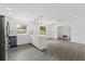 Bright and airy kitchen featuring stainless steel appliances, white cabinets, and a peninsula with pendant lighting at 7331 Blue Jacket W Pl, Winter Park, FL 32792