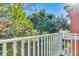 This inviting balcony offers a serene outdoor view of the lush landscaping surrounding the property at 8452 Crystal Cove Loop, Kissimmee, FL 34747