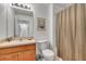 Functional bathroom with a single sink vanity, toilet, and shower with curtain at 8452 Crystal Cove Loop, Kissimmee, FL 34747