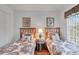 Inviting bedroom featuring twin beds, a side table with a lamp, and warm wood floors at 8452 Crystal Cove Loop, Kissimmee, FL 34747