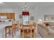 Bright dining area featuring a chandelier, wooden table with seating, and an open layout at 8452 Crystal Cove Loop, Kissimmee, FL 34747