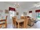 Open-concept dining area featuring a wooden table with chairs, bright natural light, and stylish decor at 8452 Crystal Cove Loop, Kissimmee, FL 34747