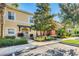 Inviting townhouse featuring a yellow exterior, landscaped front yard, and walkway leading to the entrance at 8452 Crystal Cove Loop, Kissimmee, FL 34747