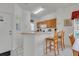 Bright kitchen featuring a breakfast bar with seating, neutral countertops, and tiled flooring at 8452 Crystal Cove Loop, Kissimmee, FL 34747