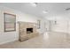 Living room showcasing a fireplace, neutral paint, tile floors, and natural light from the windows and glass door at 851 Benchwood Dr, Winter Springs, FL 32708