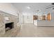 Open living space featuring a fireplace, tile floors, and a view of the kitchen with a breakfast bar at 851 Benchwood Dr, Winter Springs, FL 32708