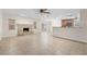 Open living room featuring a stone fireplace, tile floors, and view of the kitchen at 851 Benchwood Dr, Winter Springs, FL 32708