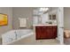 Luxurious bathroom with a soaking tub, vanity with storage, and modern fixtures at 864 Stonechase Ln, Lake Mary, FL 32746