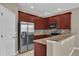 Kitchen featuring modern appliances, tile backsplash, and warm lighting, creating a functional space at 864 Stonechase Ln, Lake Mary, FL 32746