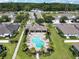 Aerial view of a community pool surrounded by lounge chairs and palm trees in a neighborhood at 864 Stonechase Ln, Lake Mary, FL 32746