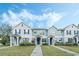 Charming townhome with well-manicured lawn, blue shutters, and inviting entryway at 8933 Newmarket Dr, Windermere, FL 34786