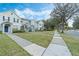Charming townhomes with blue shutters line a sidewalk, enhancing curb appeal at 8933 Newmarket Dr, Windermere, FL 34786