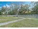 Scenic neighborhood street with mature trees and white picket fences, a peaceful setting at 8933 Newmarket Dr, Windermere, FL 34786