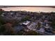 An aerial view of the neighborhood showcases a modern home near a lake at 8966 Easterling Dr, Orlando, FL 32819