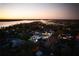 Sunset aerial view of modern home in a lakeside community at 8966 Easterling Dr, Orlando, FL 32819