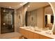 Modern bathroom with a glass-enclosed shower, double sinks, and stylish fixtures at 8966 Easterling Dr, Orlando, FL 32819