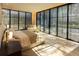 Sun-drenched bedroom featuring floor-to-ceiling windows and a neutral color palette at 8966 Easterling Dr, Orlando, FL 32819