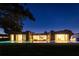 Stunning modern home exterior at night featuring a pool and manicured lawn at 8966 Easterling Dr, Orlando, FL 32819