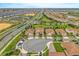 Wide aerial shot displaying the community and neighborhood including tile roofs, landscaping and roadway layout at 8995 Croquet Ct, Champions Gate, FL 33896