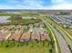 An aerial view of the community highlighting manicured green spaces, water features, and scenic roadways at 8995 Croquet Ct, Champions Gate, FL 33896