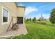 Backyard featuring a brick patio with porch swing, green lawn, and the house's exterior at 8995 Croquet Ct, Champions Gate, FL 33896