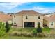 Aerial backyard view showing home exterior, lawn, trees, and tile roof at 8995 Croquet Ct, Champions Gate, FL 33896