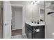 Neutral bathroom with a single sink vanity and an open doorway at 8995 Croquet Ct, Champions Gate, FL 33896