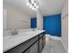 Bathroom featuring a double sink vanity with a black cabinet and a blue star-patterned shower curtain at 8995 Croquet Ct, Champions Gate, FL 33896