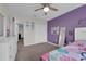 Spacious bedroom features purple wall, neutral carpet, and closet at 8995 Croquet Ct, Champions Gate, FL 33896