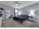 Bedroom features a neutral color scheme, ceiling fan, and a window for natural light at 8995 Croquet Ct, Champions Gate, FL 33896