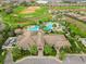 An aerial view of the community center with a pool, meticulously landscaped grounds, and convenient parking at 8995 Croquet Ct, Champions Gate, FL 33896