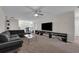 Bright living room with contemporary furniture, ceiling fan, and large-screen TV at 8995 Croquet Ct, Champions Gate, FL 33896