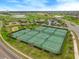 A view of the community tennis courts, offering a recreational opportunity within a lush, landscaped setting at 8995 Croquet Ct, Champions Gate, FL 33896