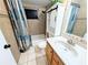 This bathroom features a tub with shower and a sink with a wooden cabinet at 9436 Montello Dr, Orlando, FL 32817