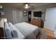 Modern bedroom with hardwood floors features a ceiling fan, built in shelves and closet at 9436 Montello Dr, Orlando, FL 32817