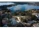 Stunning aerial shot of a neighborhood nestled beside a serene lake and verdant trees at 105 Pine Street, Windermere, FL 34786